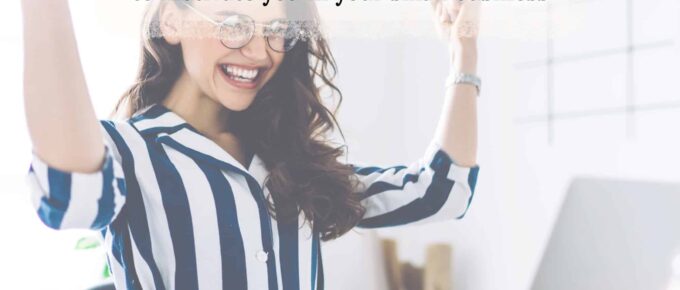 a women cheering at her desk with the overlay of the title of this article - square image