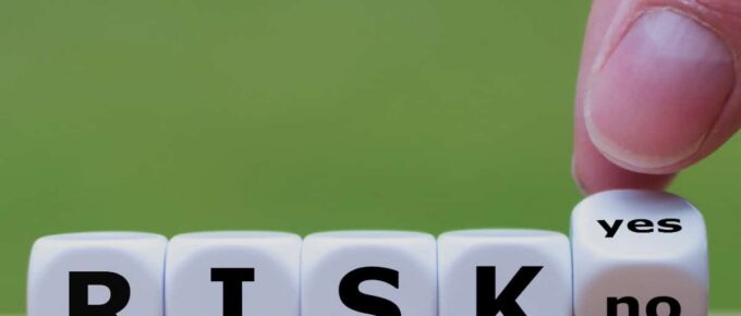 there are dice that say risk yes or no - title of post at the top center - square image